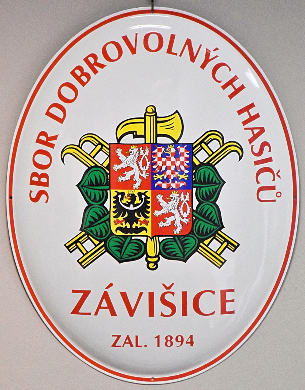 Hasičský ovál se znakem SH ČMS a s velkým státním znakem ČR.