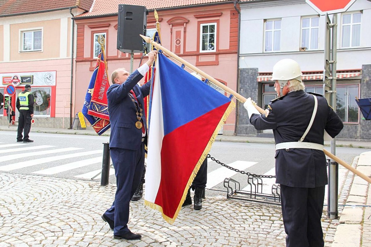 Dekorování českého státního praporu pamětní výroční stuhou.